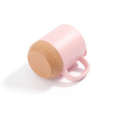 Bottom view of matte pink 13oz sublimation mug with detachable cork base, emphasizing non-slip and heat-resistant features for daily use.
