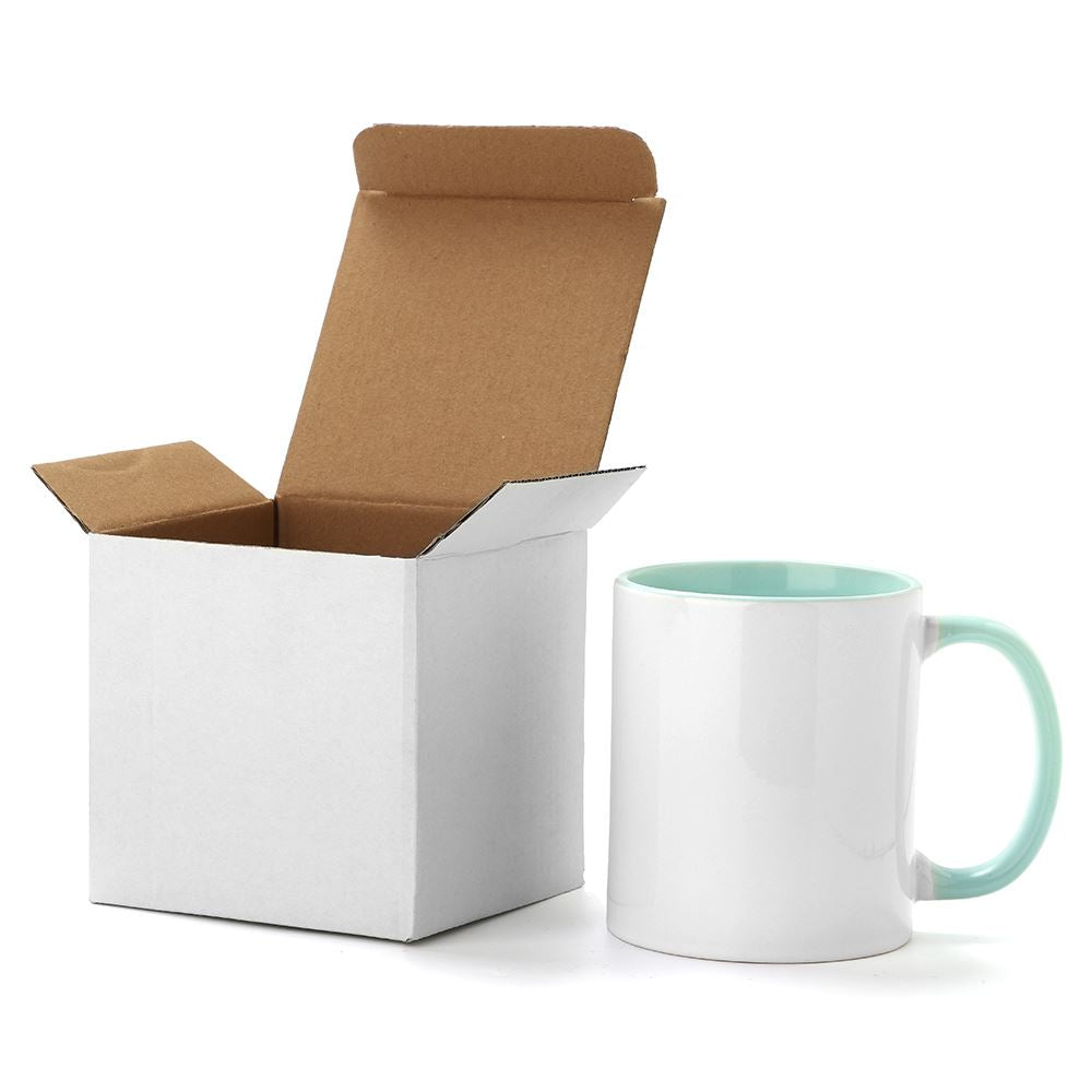 11oz mint green inner and handle ceramic mug next to a white smash-proof packaging box, perfect for secure shipping and gifting.