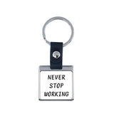 Square metal sublimation keyring with black strap and 'Never Stop Working' text, blank for engraving or printing.