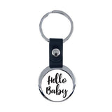Round metal and black leather keyring with 'Hello Baby' text, suitable for sublimation or engraving.