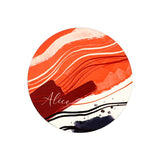 Round sublimation blank with abstract orange, red, and black artistic waves, customizable surface.