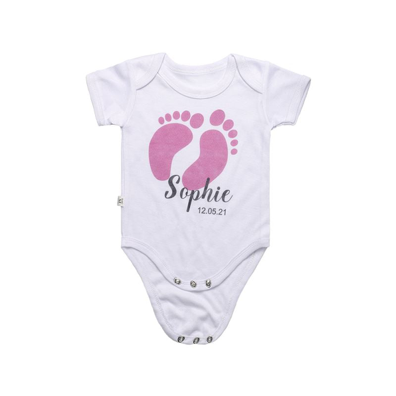 White sublimation baby bodysuit with pink footprint design and personalized text