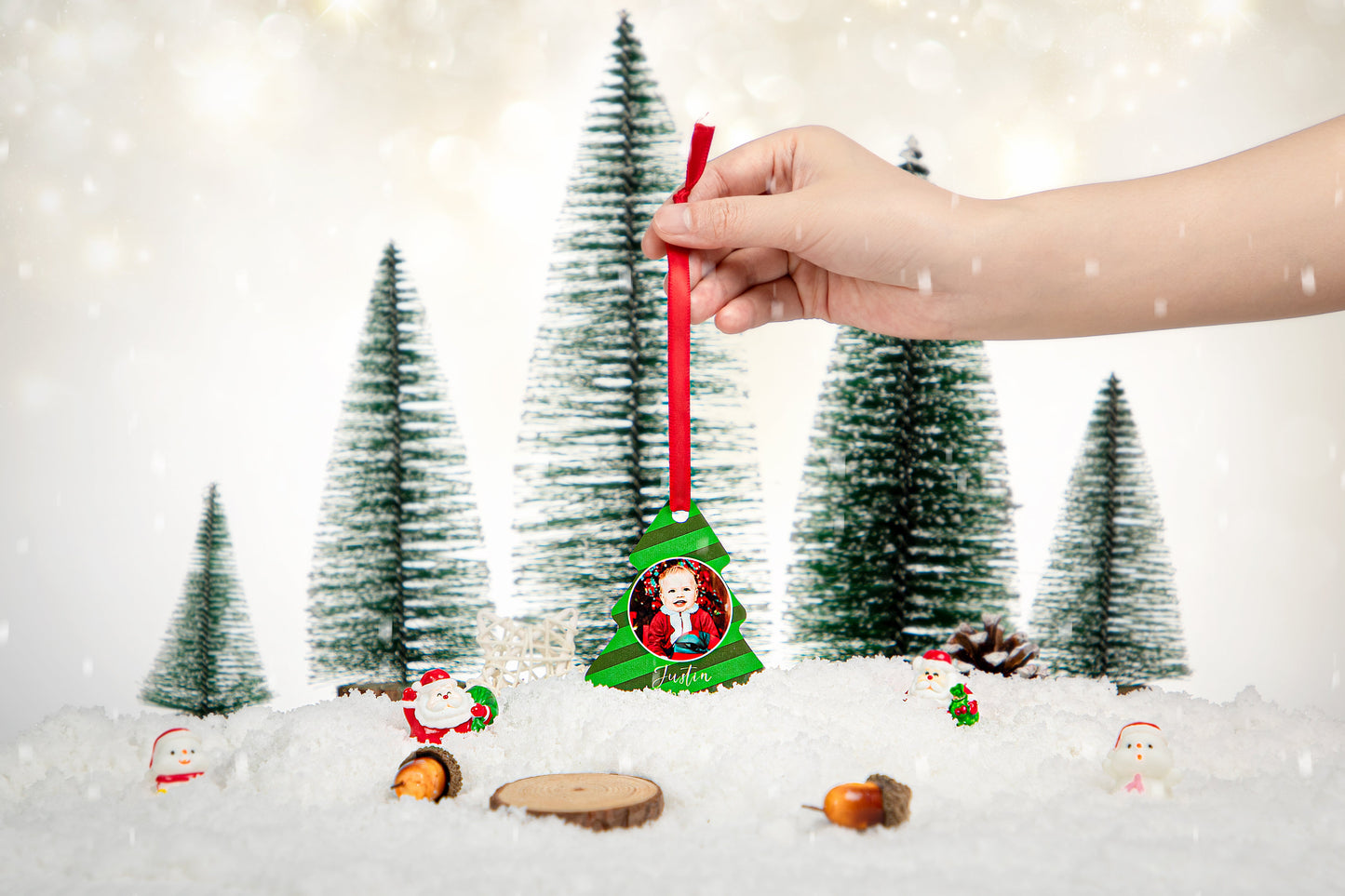 Hand holding double-sided aluminium Christmas tree ornament for sublimation in snowy scene