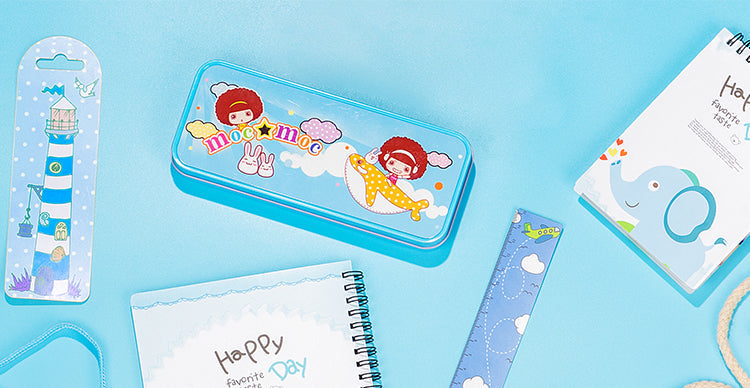 Blue metal stationary tin for sublimation, surrounded by notebooks and bookmarks on blue background