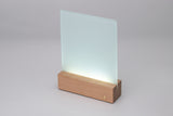 Angled view of sublimation-ready glass photo panel with LED wooden base, designed for personalized light-up decor.