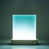 Illuminated glass photo panel with LED base glowing in blue and white gradient, suitable for custom light-up photo displays.