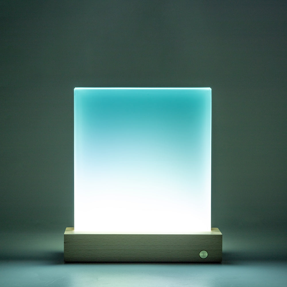 Illuminated glass photo panel with LED base glowing in blue and white gradient, suitable for custom light-up photo displays.