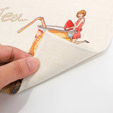 Linen sublimation coaster with colorful printed design, hand lifting corner to show texture