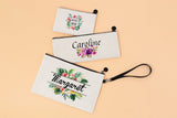 Set of three linen cosmetic pouches with floral sublimation designs and personalized names
