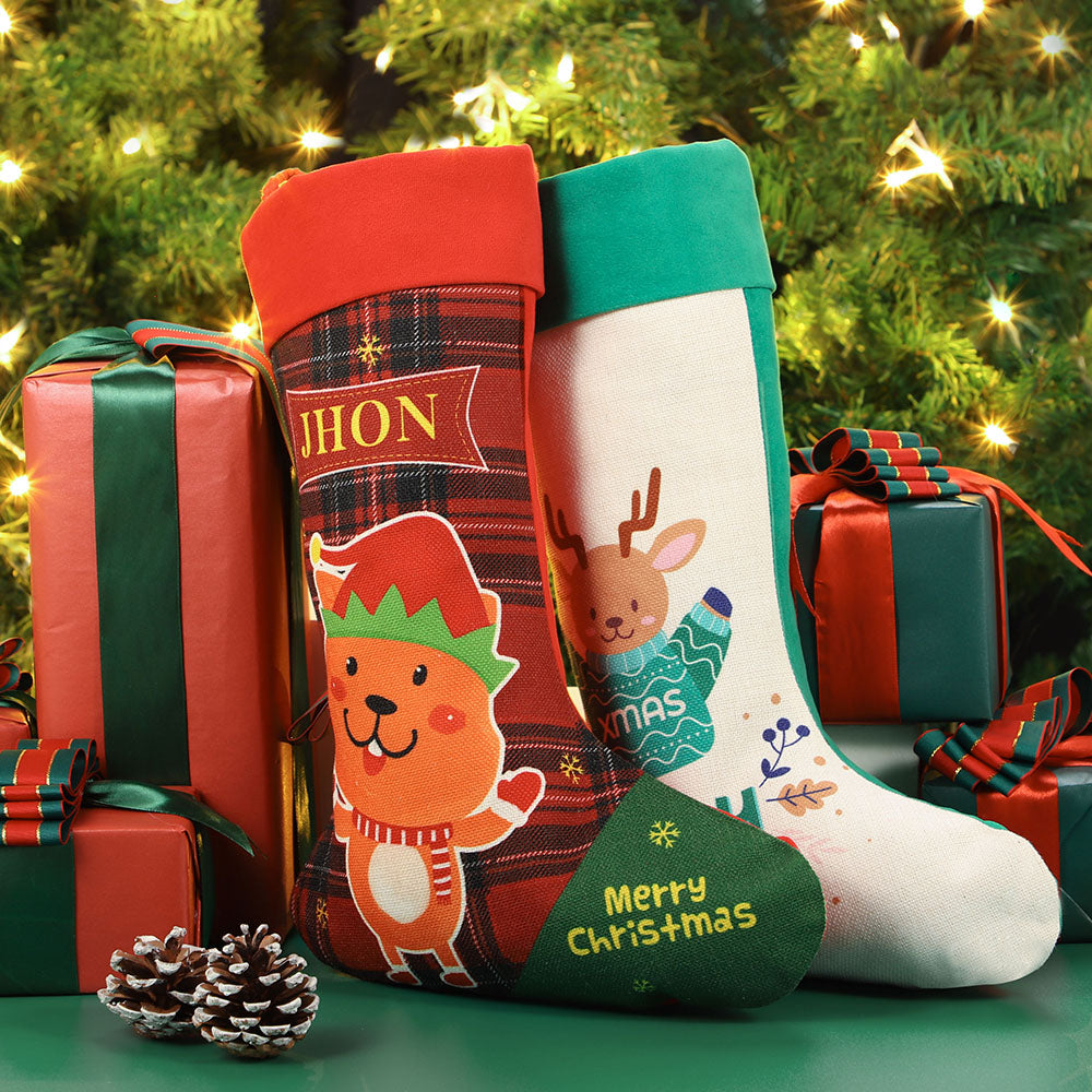 Linen red Christmas stocking with elf and reindeer cartoon, sublimation blank ready for personalization, set by Christmas tree with gifts.