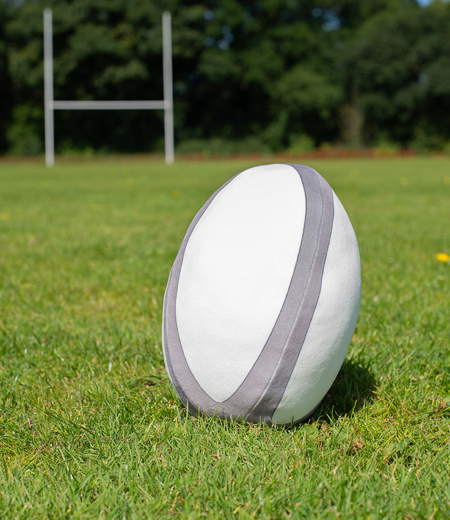 Mumbles Zippie rugby ball resting on grass field, perfect for cuddling and personalisation.