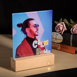 Glass Photo panel with LED Base displays a custom sublimated image of a man with 'Calm Down' text, glowing softly on a wooden base.