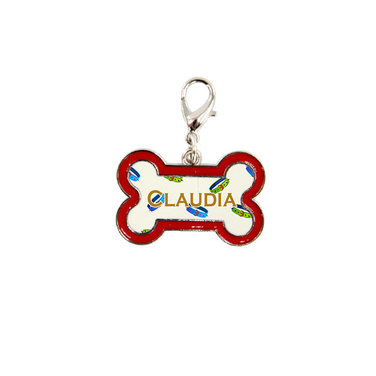Personalized dog bone-shaped metal tag with red border and name CLAUDIA for sublimation